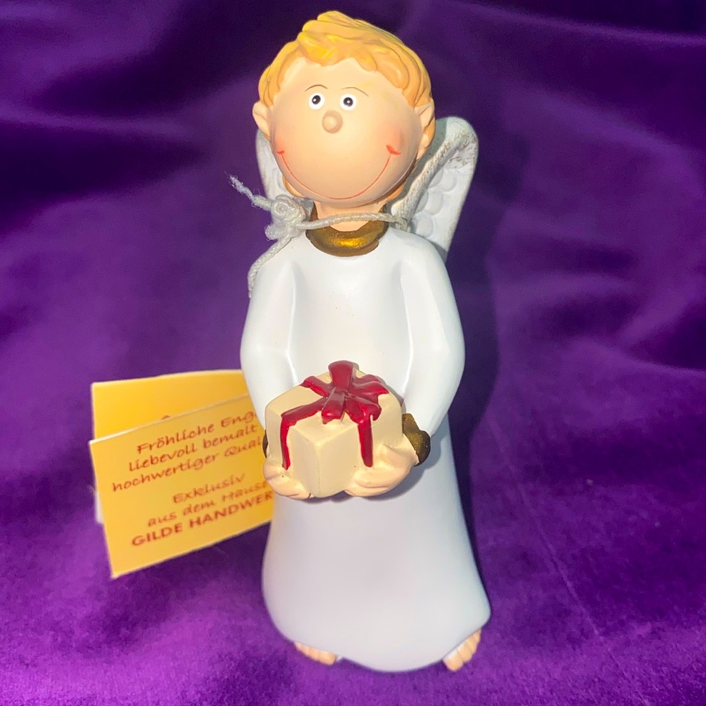 Gilde Angel figurines and Ornaments. Item no: 28048. Standing boy holding gift.